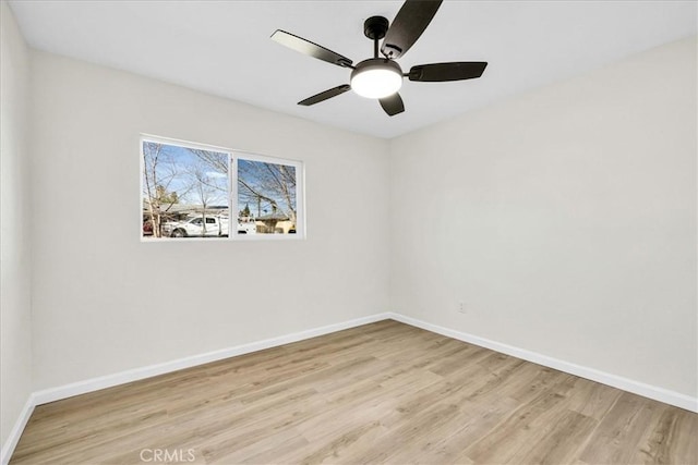 unfurnished room featuring light wood finished floors, a ceiling fan, and baseboards