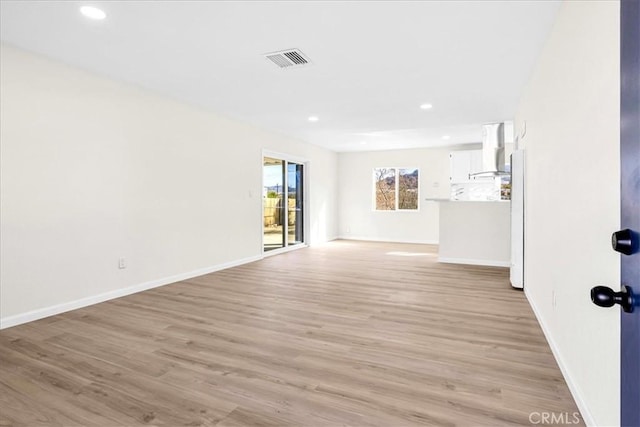 unfurnished living room featuring baseboards, recessed lighting, visible vents, and light wood-style floors