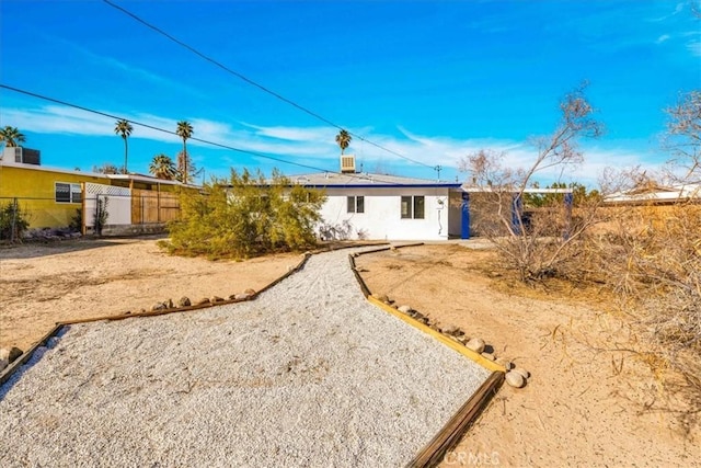 back of house with fence