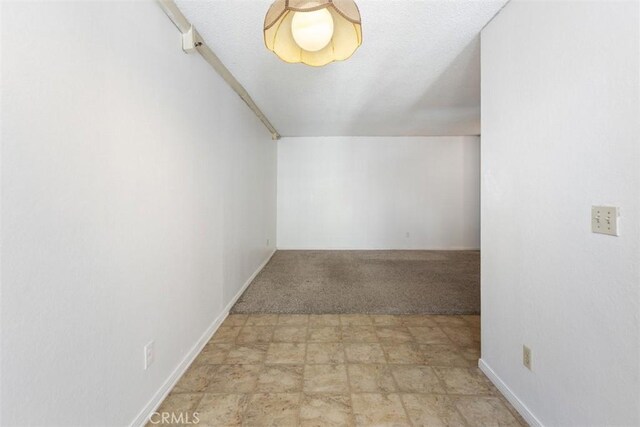 7506 Parkway Dr Unit 104, La Mesa, CA 91942 - bonus room with baseboards, light colored carpet, and stone finish floors