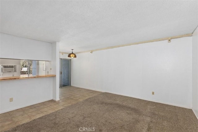 7506 Parkway Dr Unit 104, La Mesa, CA 91942 - unfurnished living room featuring a textured ceiling, baseboards, and a wall mounted AC