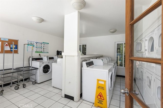 shared laundry area featuring light tile patterned floors and separate washer and dryer