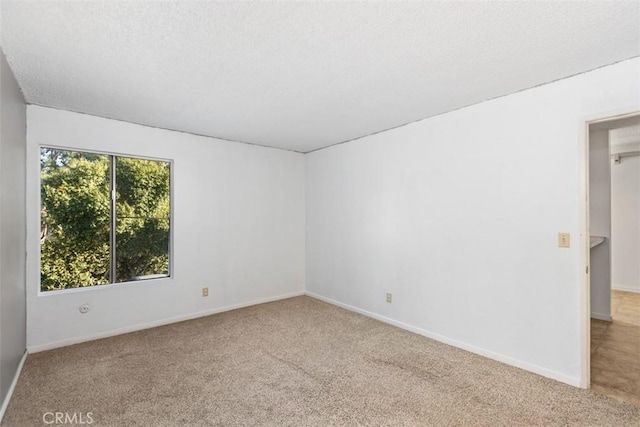 7506 Parkway Dr Unit 104, La Mesa, CA 91942 - carpeted empty room with baseboards and a textured ceiling