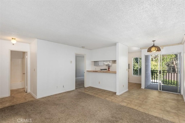 7506 Parkway Dr Unit 104, La Mesa, CA 91942 - unfurnished living room with a textured ceiling and baseboards