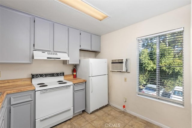 kitchen featuring a wall unit AC, butcher block countertops, white appliances, under cabinet range hood, and baseboards