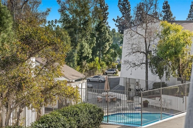 view of pool featuring a patio area, fence, and a fenced in pool