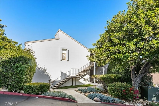 7506 Parkway Dr Unit 104, La Mesa, CA 91942 - view of side of home featuring stairs and stucco siding