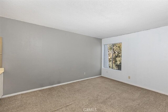7506 Parkway Dr Unit 104, La Mesa, CA 91942 - empty room featuring carpet and baseboards