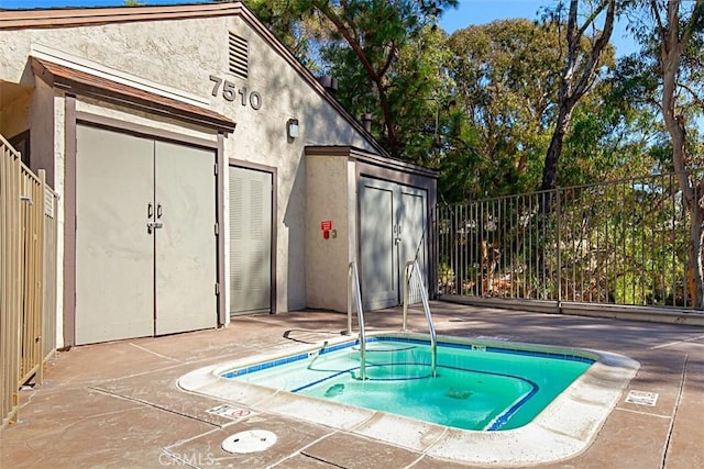 view of pool featuring fence and a patio