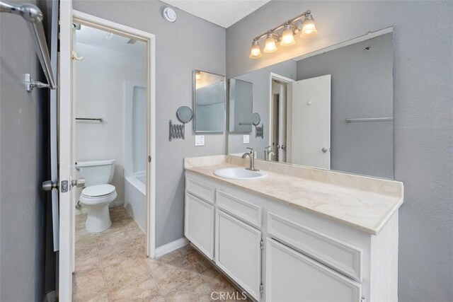 7506 Parkway Dr Unit 104, La Mesa, CA 91942 - bathroom featuring vanity, toilet, and baseboards