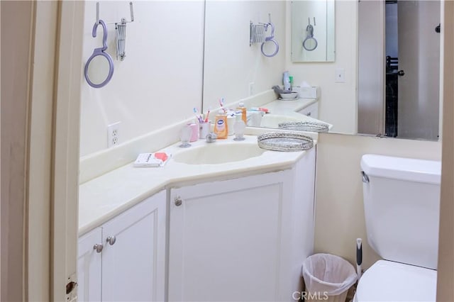 half bathroom featuring toilet and vanity