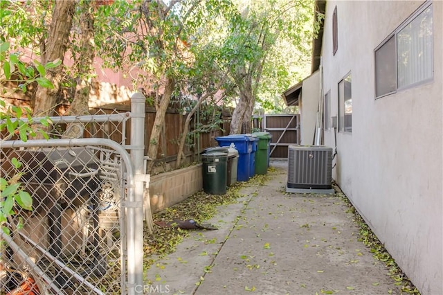 exterior space with stucco siding, fence, and central air condition unit