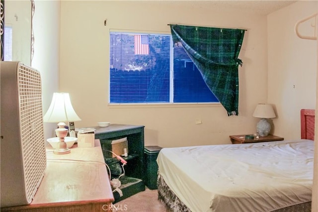 bedroom with multiple windows and carpet flooring