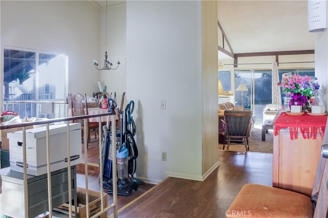 interior space featuring a notable chandelier, baseboards, and wood finished floors