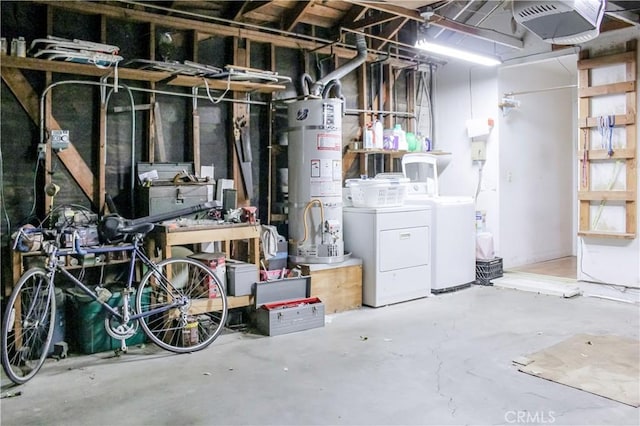 below grade area featuring water heater and washing machine and clothes dryer