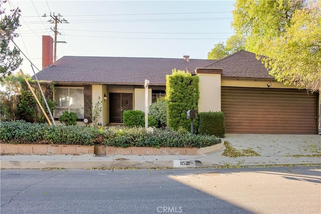 ranch-style house with a shingled roof and stucco siding