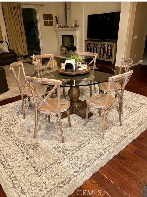 dining space with dark wood-style flooring and baseboards