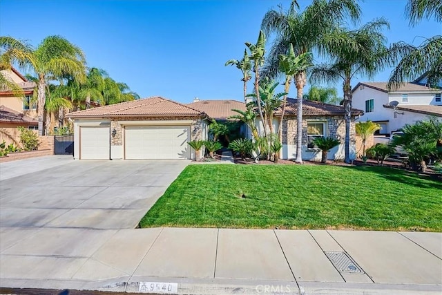 view of front facade with a garage, concrete driveway, a tile roof, a front lawn, and stucco siding