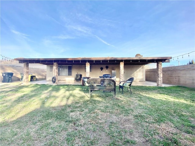 rear view of house with a yard, a patio area, fence, and cooling unit