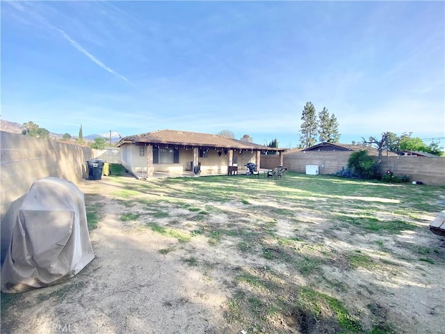 back of house with a fenced backyard