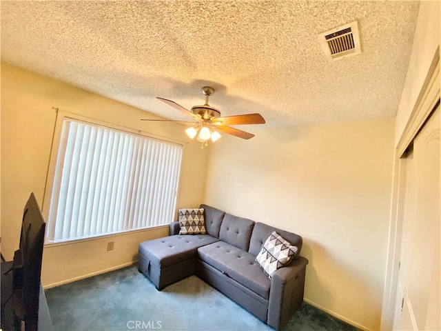 living room featuring ceiling fan, dark colored carpet, visible vents, and baseboards