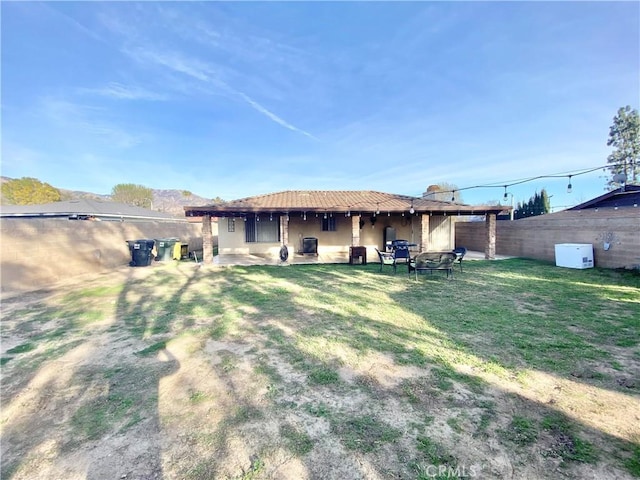 back of house with a yard, central AC unit, and fence