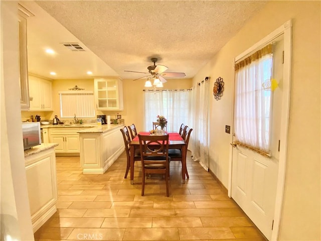 dining space with a textured ceiling, visible vents, a ceiling fan, and recessed lighting