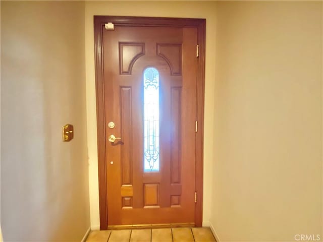 foyer featuring light tile patterned floors and baseboards