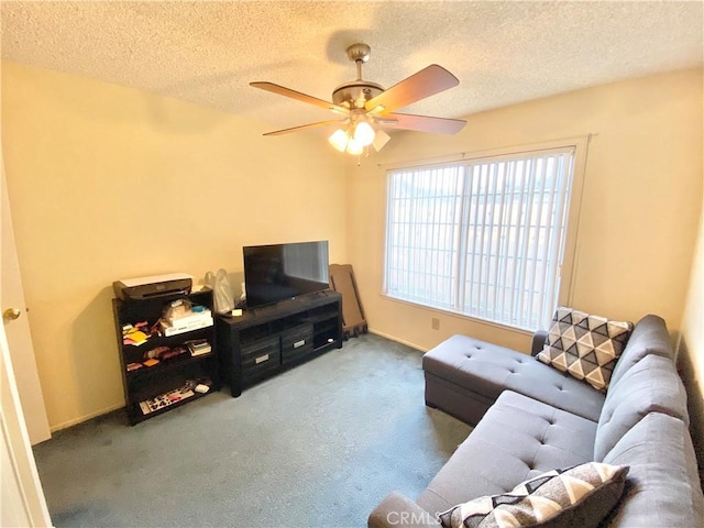 carpeted living area featuring a ceiling fan and a textured ceiling