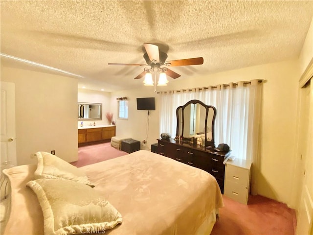 bedroom with a textured ceiling, ceiling fan, and light colored carpet