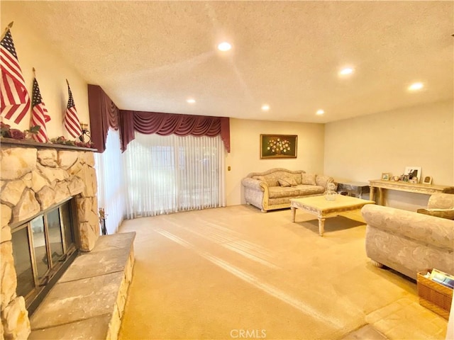 carpeted living room with a textured ceiling, a fireplace, and recessed lighting