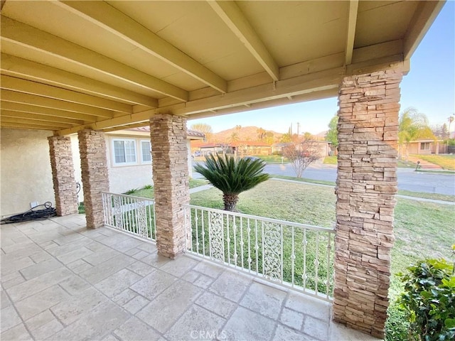 view of patio with covered porch and a mountain view