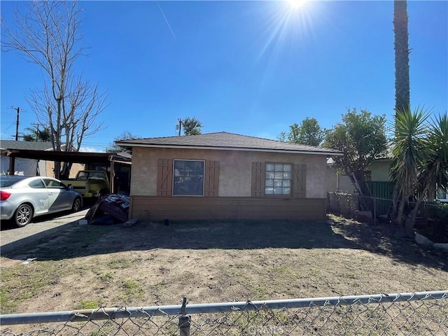 view of front of home featuring fence and stucco siding