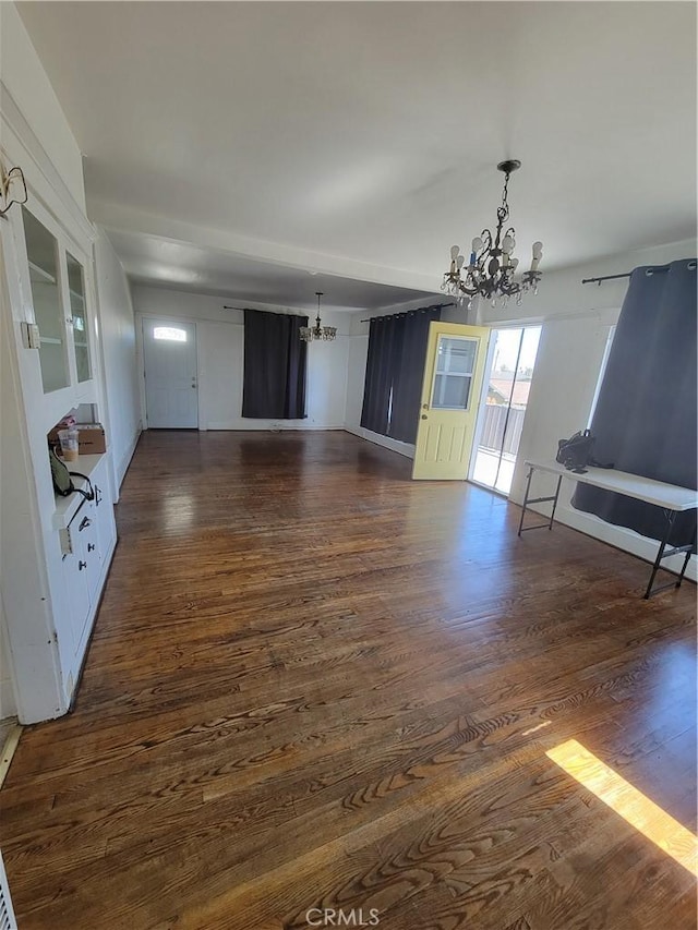 interior space with dark wood-style flooring and a notable chandelier