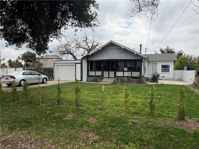 view of front of home with an attached garage, fence, concrete driveway, and a front yard