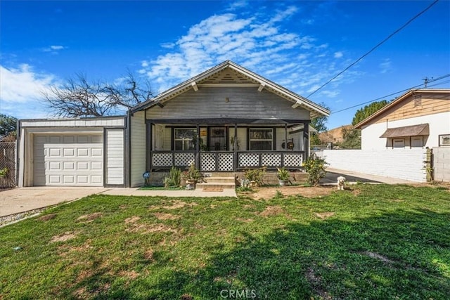 view of front of property featuring driveway, a front lawn, fence, and a porch