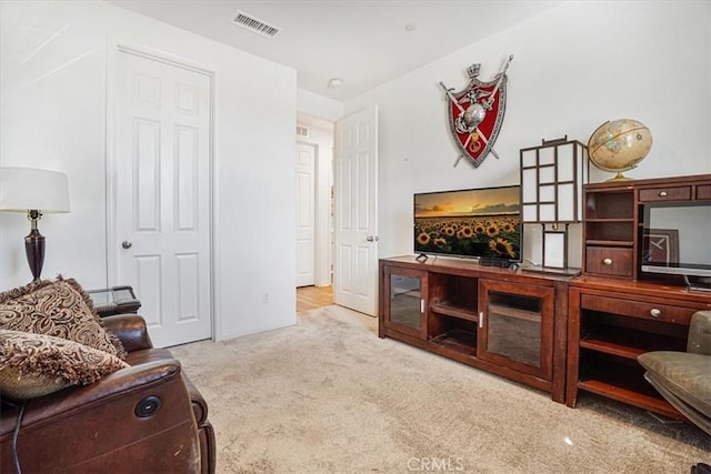 sitting room featuring light carpet and visible vents