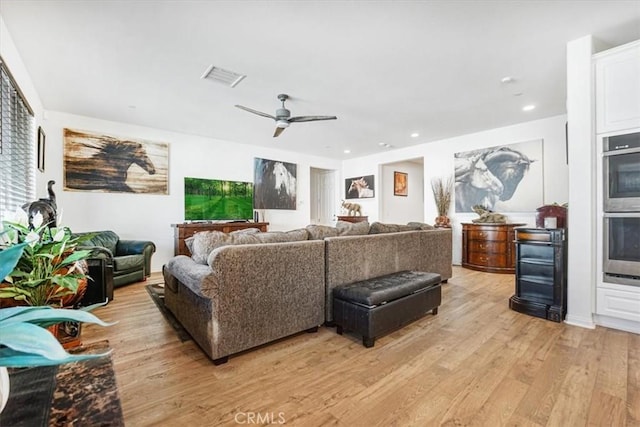 living area featuring ceiling fan, recessed lighting, visible vents, and light wood-style floors