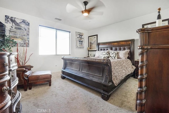 bedroom with a ceiling fan, visible vents, and light carpet