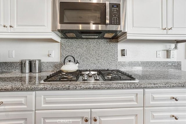 kitchen with appliances with stainless steel finishes and white cabinets