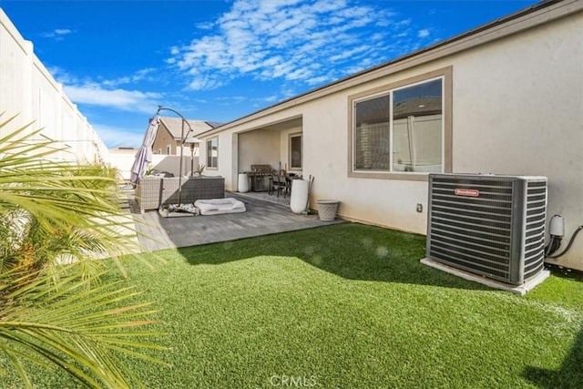 view of yard with a patio area, a fenced backyard, and central AC unit