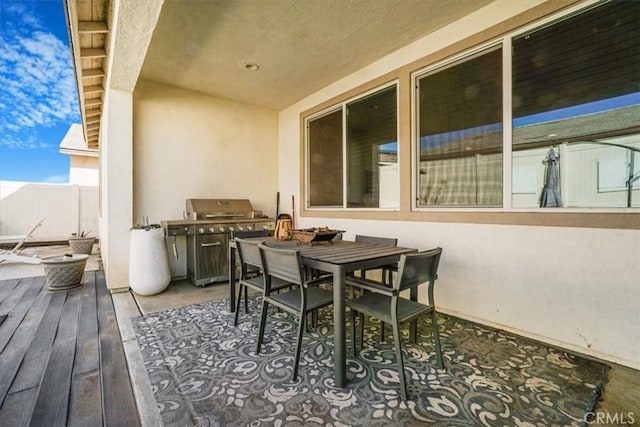 balcony featuring outdoor dining area and a grill