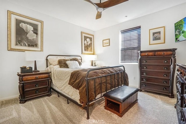 bedroom featuring light colored carpet, ceiling fan, and baseboards