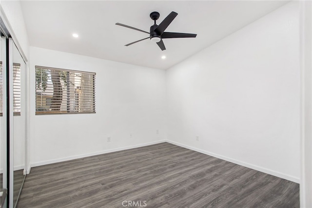 unfurnished bedroom featuring dark wood-style floors, baseboards, a closet, and recessed lighting