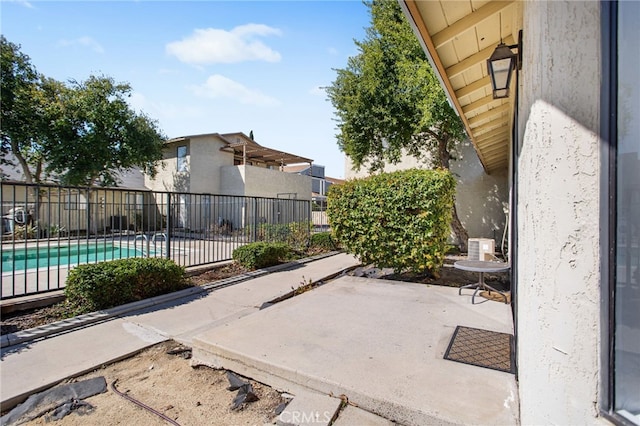 view of patio with cooling unit, fence, and a fenced in pool