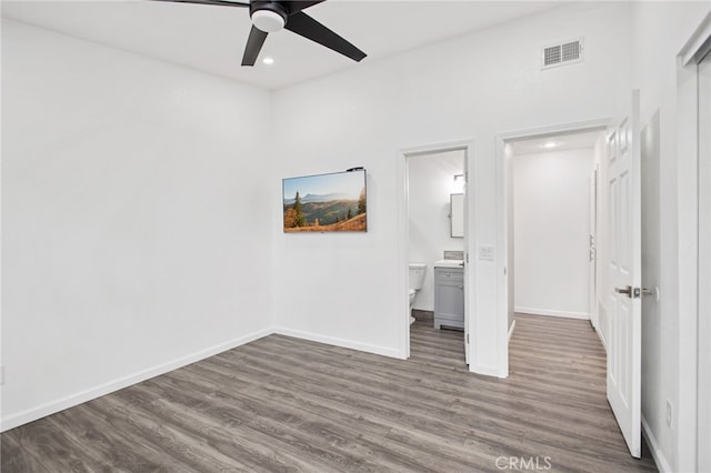 unfurnished bedroom with dark wood-type flooring, visible vents, and baseboards