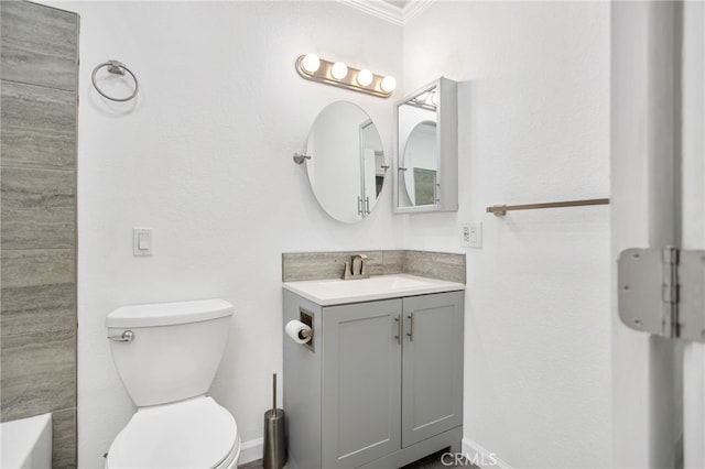 full bathroom featuring ornamental molding, vanity, and toilet