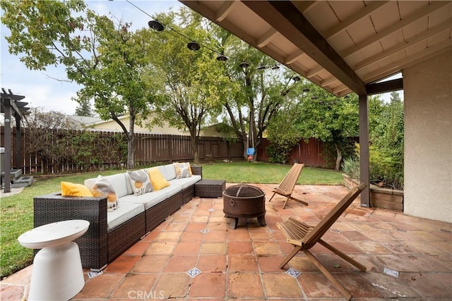 view of patio featuring an outdoor living space with a fire pit and a fenced backyard