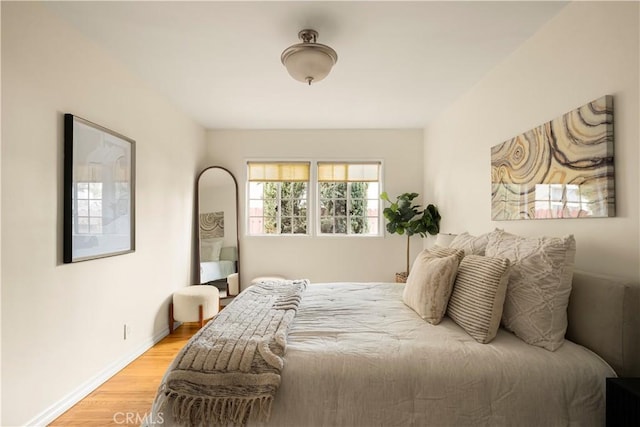 bedroom featuring light wood-style flooring and baseboards