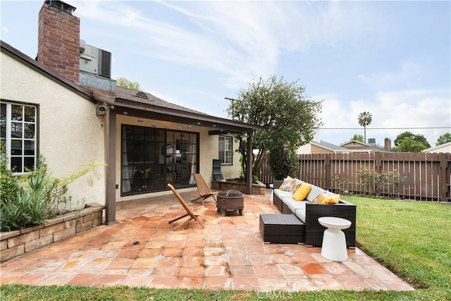 view of patio / terrace featuring an outdoor living space with a fire pit and fence